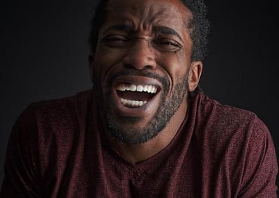 laughing black man with beard.